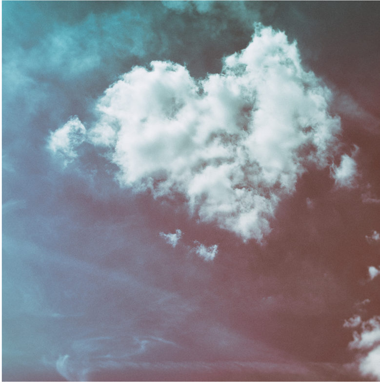 Photograph of a heart-shaped cloud in a blue sky