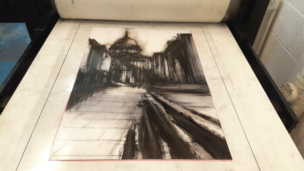 Etching of London and St Paul's Cathedral by Clare Grossman on the printmaking press